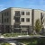 a large building with trees and grass