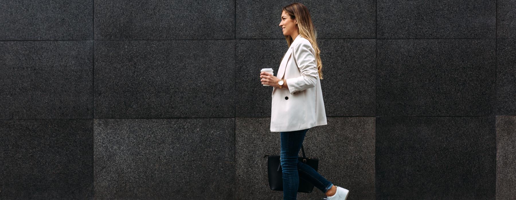 a person walking in front of a wall