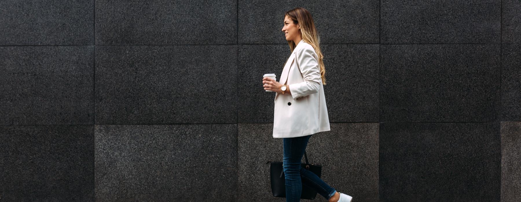 a person walking in front of a wall